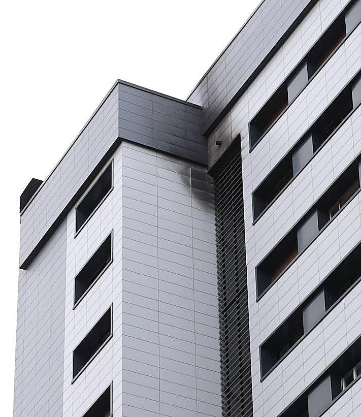 Imagen secundaria 2 - Cartel de la Ertzaintza pidiendo a los vecinos afectados que denuncien. Dos vecinos evaluaban ayer los daños provocados por el fuego.. La viviend afectada por el incendio.