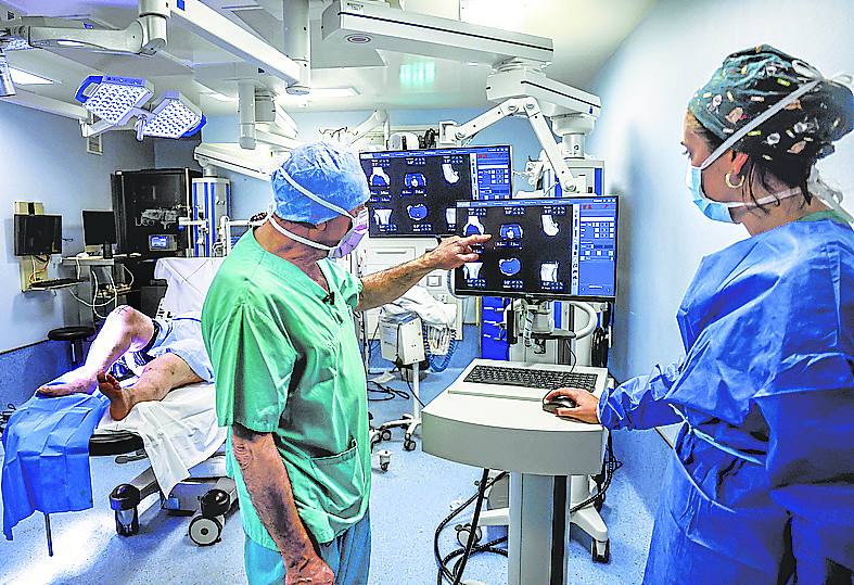 Sánchez y la ingeniera repasan la operación que hará el robot.