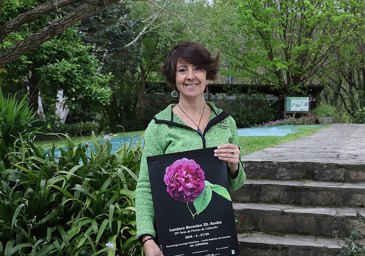 Aran Aldai sostiene el cartel de la feria en las instalaciones del jardín botánico de Iturraran.