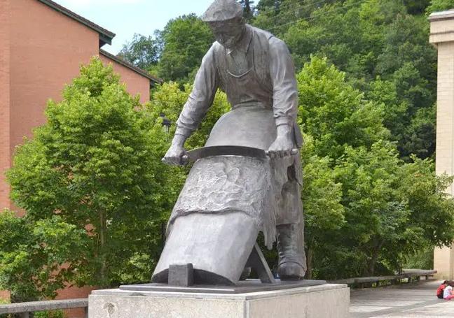 Monumento en bronce de la plaza Zurrategi de Antzuola, obra del artista Luis Beitia, que representa a un trabajador descarnando una piel.