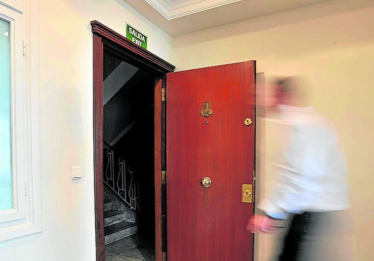 Un cliente sale de un piso turístico.