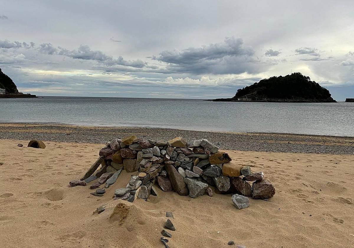 Los recientes episodios meteorológicos extremos han aflorado un manto de piedras en la playa de Ondarreta. La orilla está plagada de pequeños cascotes, como puede apreciarse con marea baja, pero también han aparecido bloques de mayor tamaño que alguien se ha dedicado a apilar sobre la arena, formando un muro que ayer sorprendió a paseantes y bañistas.