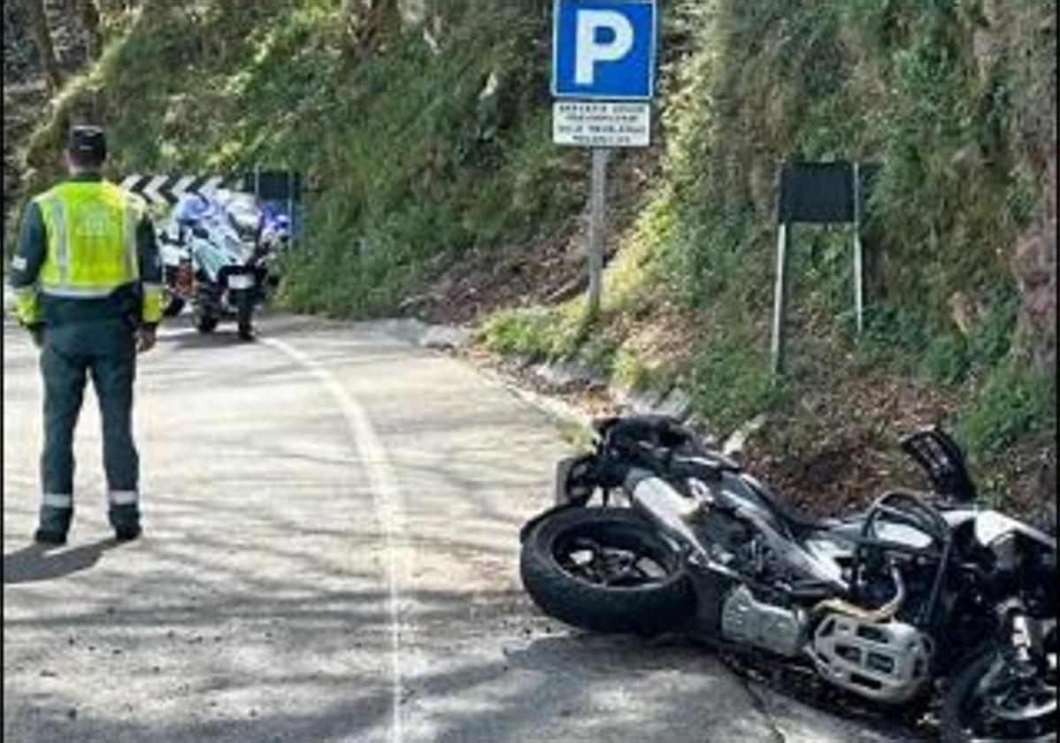 Un Guardia Civil junto a la motocicleta salida de la vía.