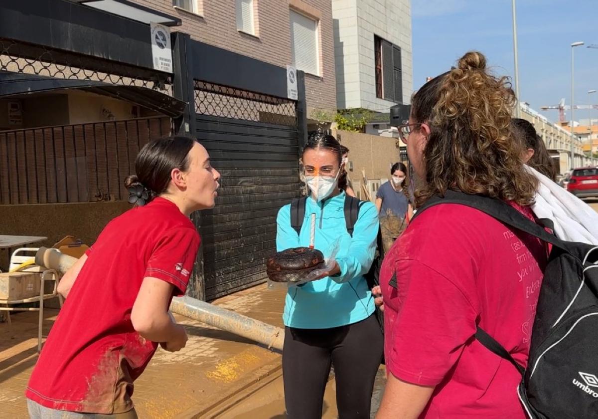 Esther recibe una tarta de cumpleaños de parte de dos amigas que la visitaron.