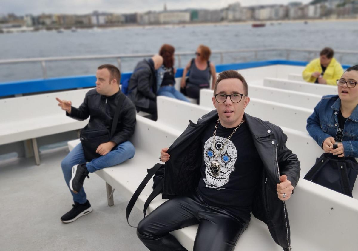 Imagen principal - Iñaki Lahortiga con su camiseta, Ainhoa Suescun con el timón del barco en Donostia e Iñaki Alforja, director del documental.
