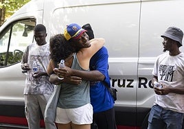 Uno de los malienses abraza a una vecina de Amara Berri antes de montar en una de las furgonetas de la Cruz Roja.