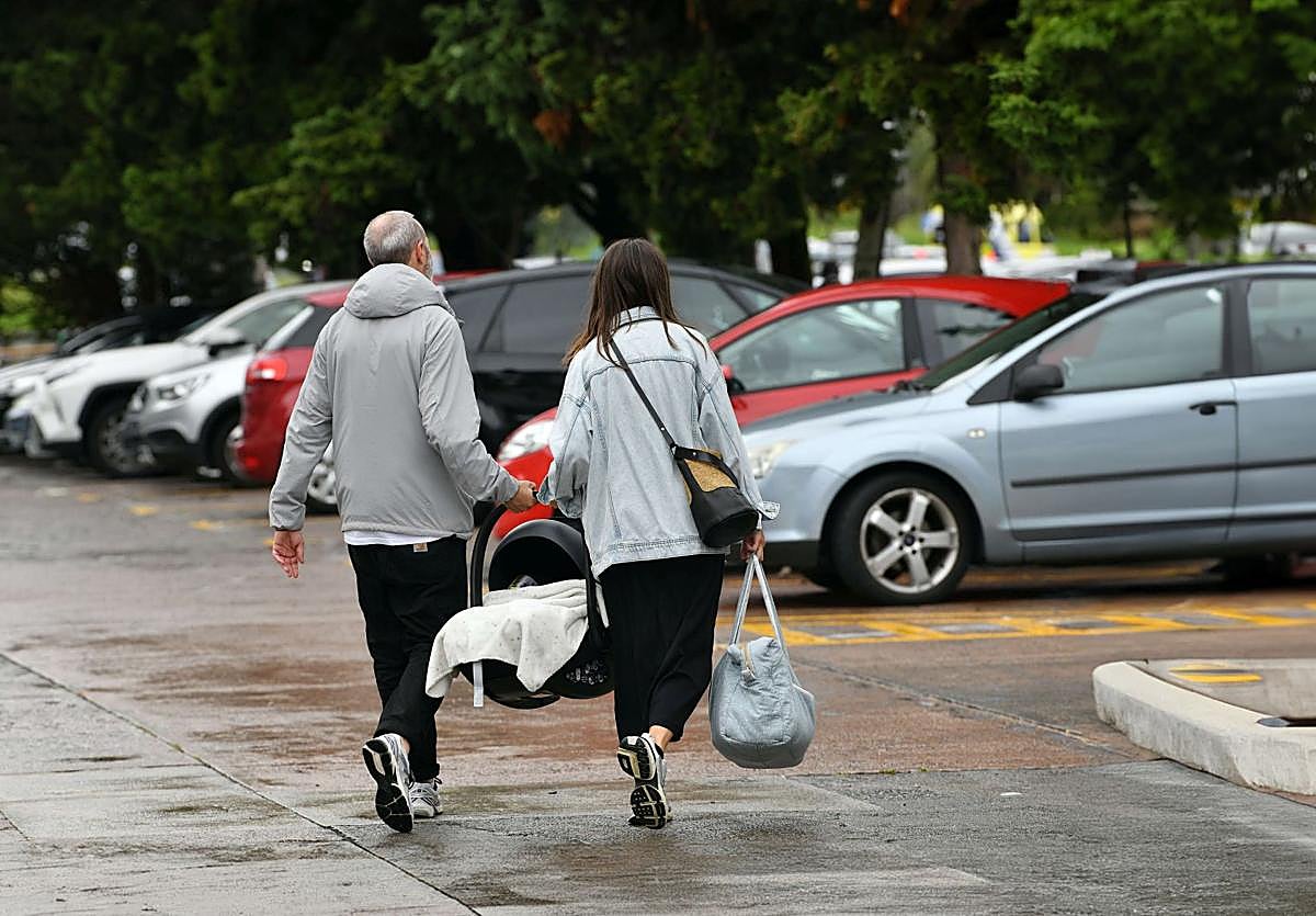 Una pareja sale del hospital con su hijo recién nacido