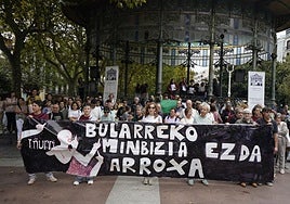 Algunas de las personas que se han acercado a la marcha contra el Cáncer de Mama junto a una pancarta con el mensaje 'el cáncer de mama no es rosa'.