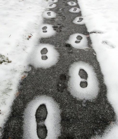 Huellas en la nieve delatan a un caminante invernal. 