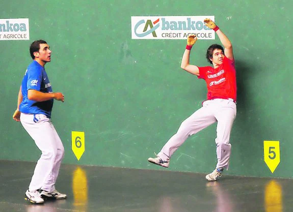 Iker Irribarria saca una pelota de la pared izquierda en el frontón de Idiazabal.