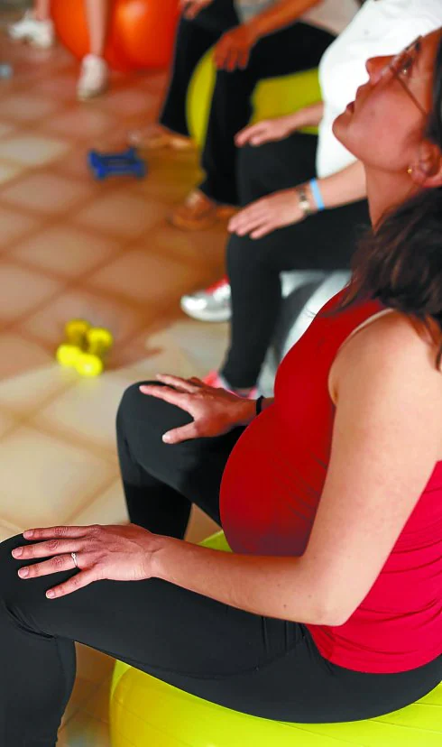 Un grupo de mujeres embarazadas realizan unos ejercicios.