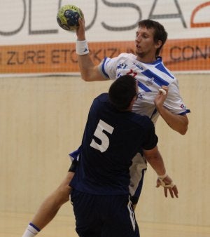 Un jugador del Arrate pasa antes de chocar con un rival. /MICHELENA