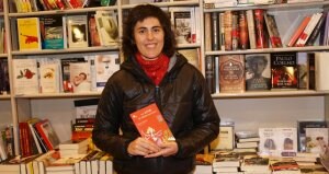 Antxiñe Mendizabal posa en una librería con su libro en la mano. /ARESTI