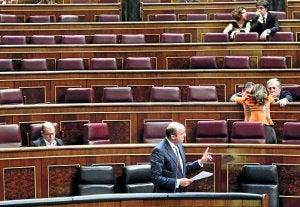 El ministro de Economía y Competitividad, Luis de Guindos, explica su propuesta de dación en pago en un hemiciclo casi vacío. ::                             EFE