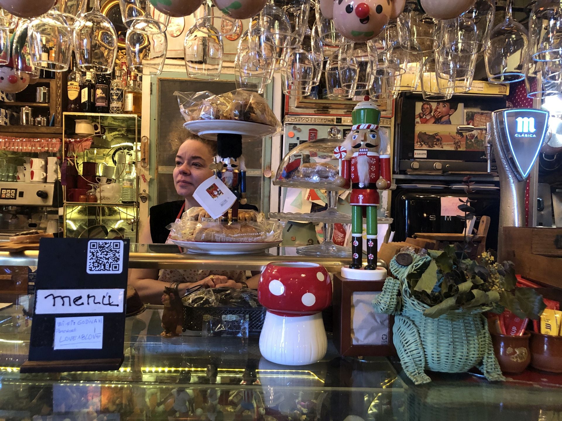 La propietaria detrás de la barra del bar.