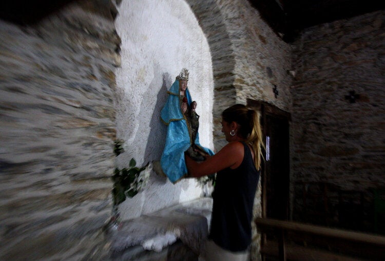La Santa de Lusio vuelve a la iglesia tras el incendio que ha arrasado el pueblo.