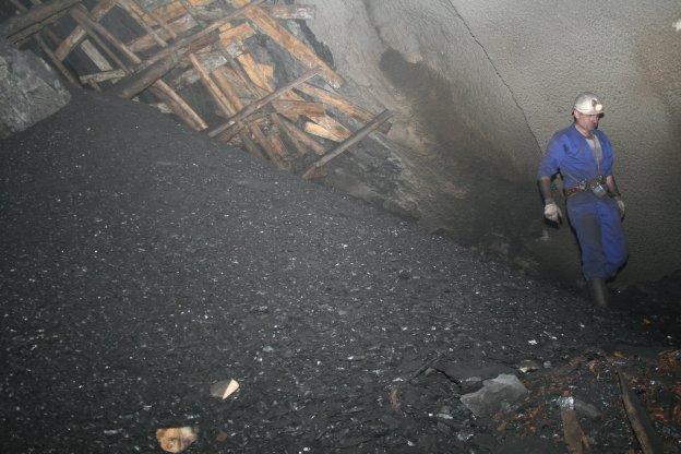 Un minero pasa junto a una pila de carbón en una de las galerías del pozo Cerredo. 