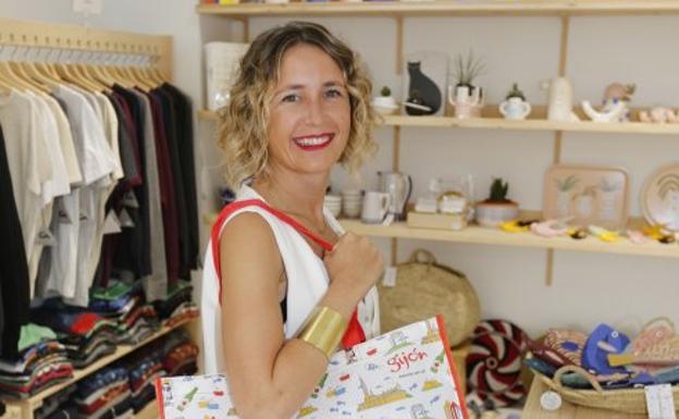 Ana Junquera, con una bolsa diseñada por ella, en su tienda gijonesa, La Cósmica.