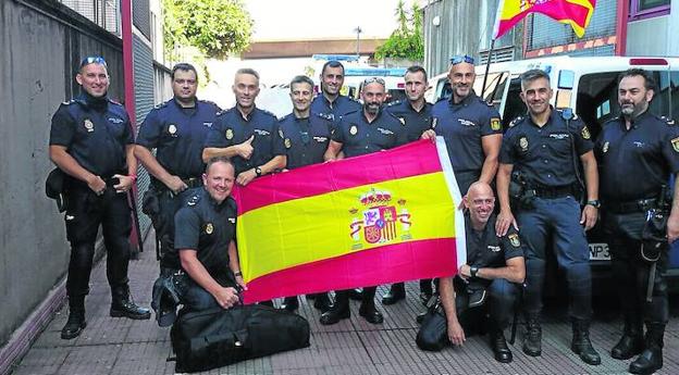 El grupo de policías gijoneses posa con la bandera de España poco antes de partir de Pineda del Mar hacia Monzón. 