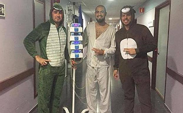 Marcos Rosa en el hospital, junto a dos amigos que fueron a visitarle así vestidos para subirle el ánimo 