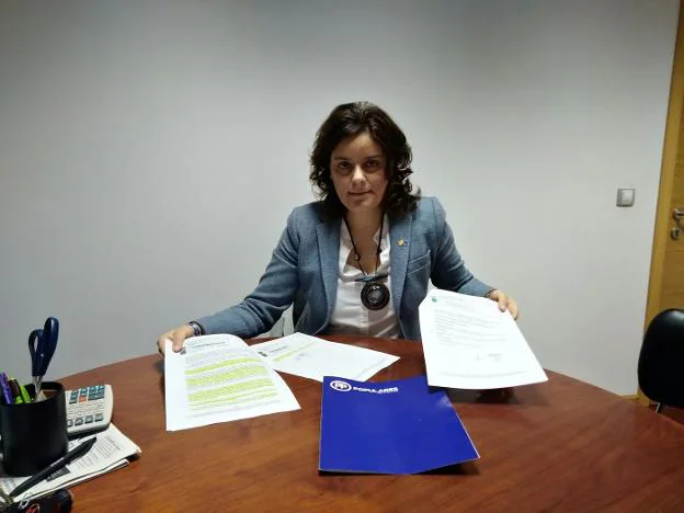 La portavoz del PP de Siero, Beatriz Polledo, mostrando el informe jurídico y el acta de la comisión. 