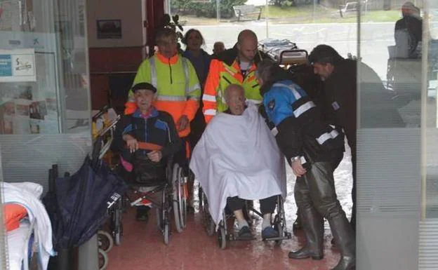 Dos ancianos a la espera de ocupar su turno en una ambulancia para ser trasladados de residencia el pasado domingo. 
