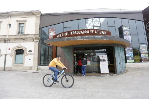 Un ciclista pasa frente a la entrada del Museo del Ferrocarril. 