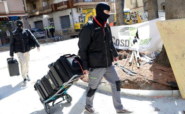 Un agente de la Guardia Civil recoge documentación en Viladecans.