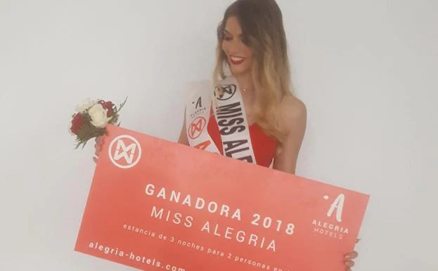Rocío Fidalgo con el cartel y la banda que la acreditan como Miss Alegría 2018. 