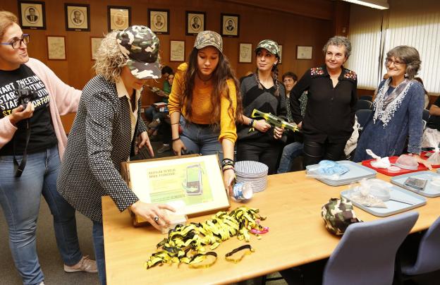 Eva García y Pilar Cartón, ambas a la derecha, con alumnas de la EPI, en el reparto de pulseras de Amnistía Internacional. 