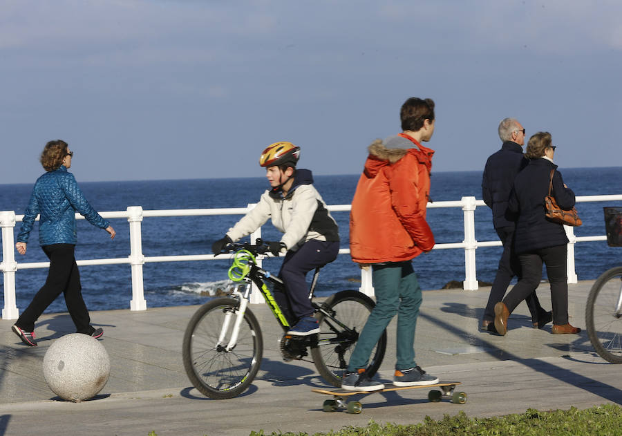 A pesar del frío, los gijoneses no han desperdiciado la oportunidad de disfrutar de la ausencia de nubes, ya sea paseando, en bicicleta o corriendo.