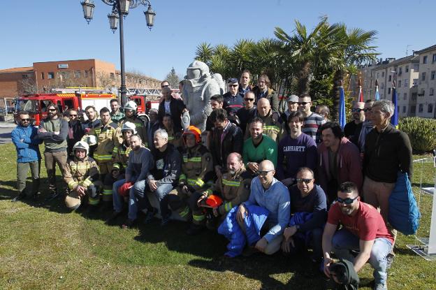 Foto de familia de todos los bomberos de Oviedo con la estatua.