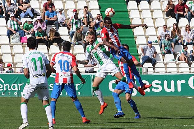 Cofie gana un duelo por alto con el goleador local, Carrillo. 