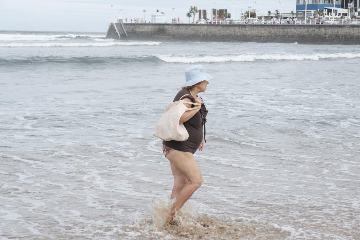 Una bañista camina por la orilla en la zona de la playa que estuvo cerrada preventivamente. 