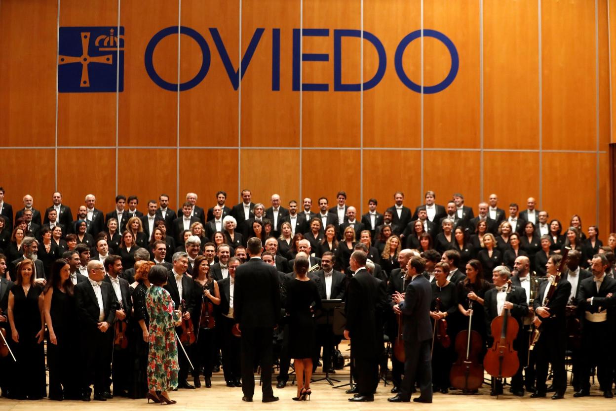 Los reyes Felipe y Letizia (de espaldas) con la orquesta tras el XXVII Concierto Premios Princesa de Asturiasdel año pasado en el Auditorio Príncipe Felipe de Oviedo. 