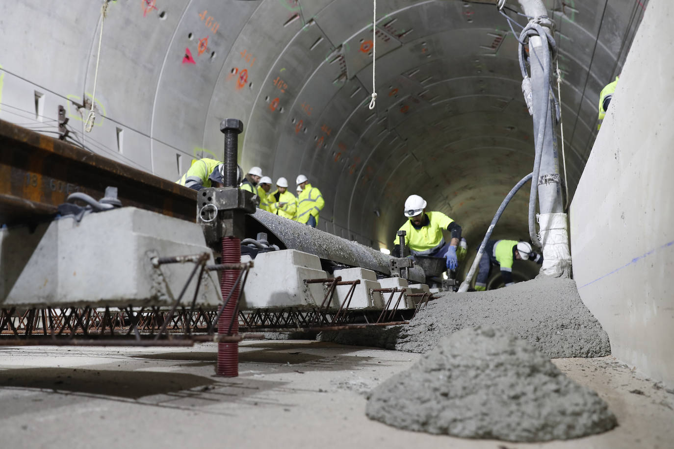 Final. Con la vía ya afinada, se libera mediante varias mangas el hormigón que llega desde el otro túnel y se extiende.