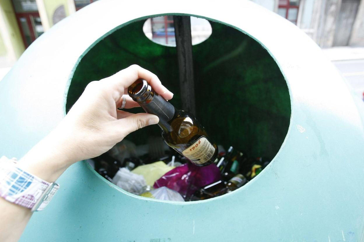 Reciclaje de vidrio en un contenedor instalado en Avilés. 