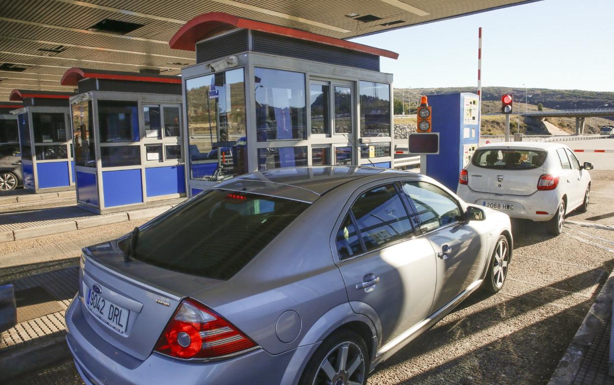 Hilera de turismos pasando por las cabinas de pago de La Magdalena, en León. 