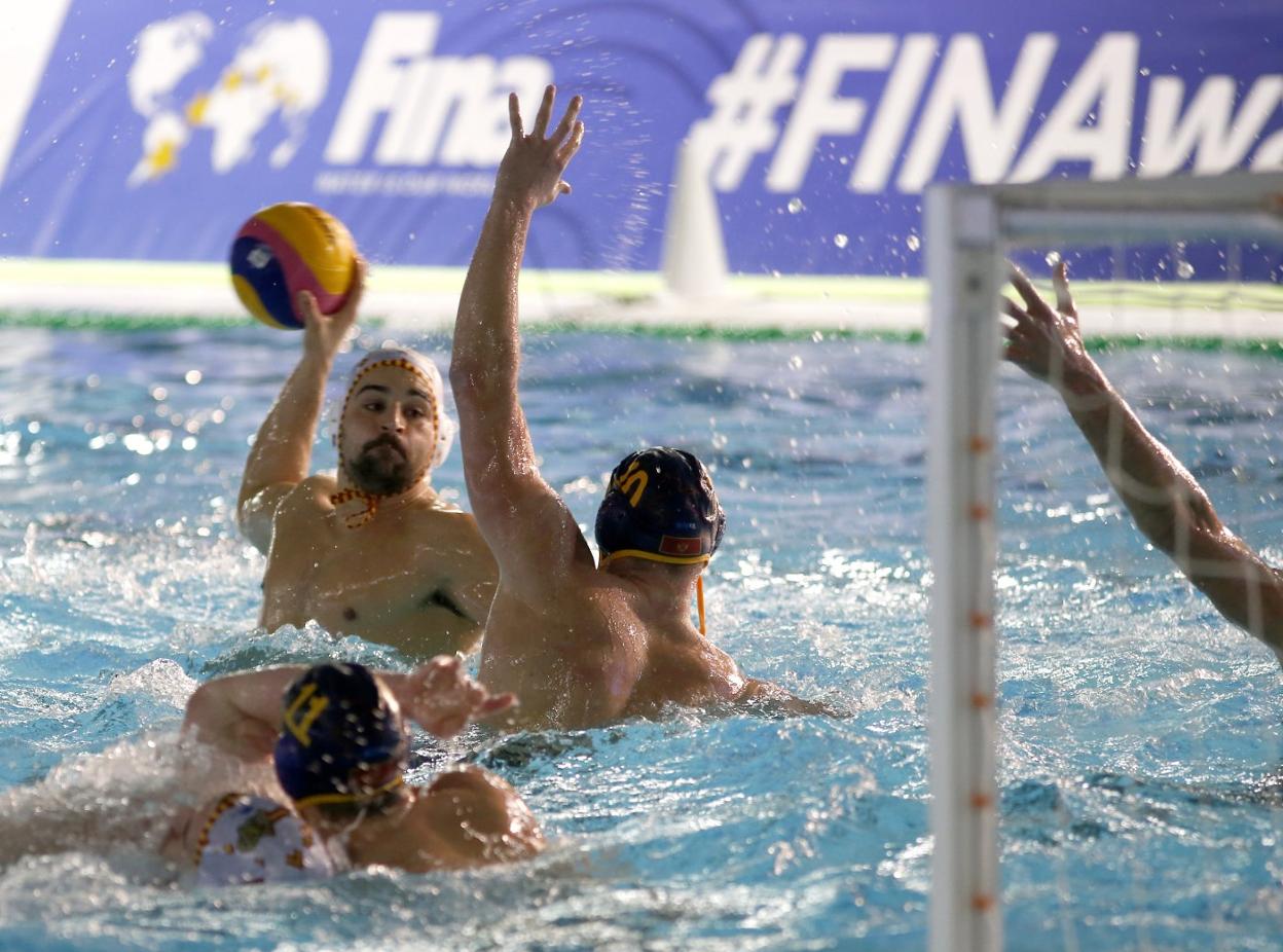 El jugador español Alberto Barroso se prepara para lanzar ante la oposición de un rival montenegrino en la piscina del Parque del Oeste. 