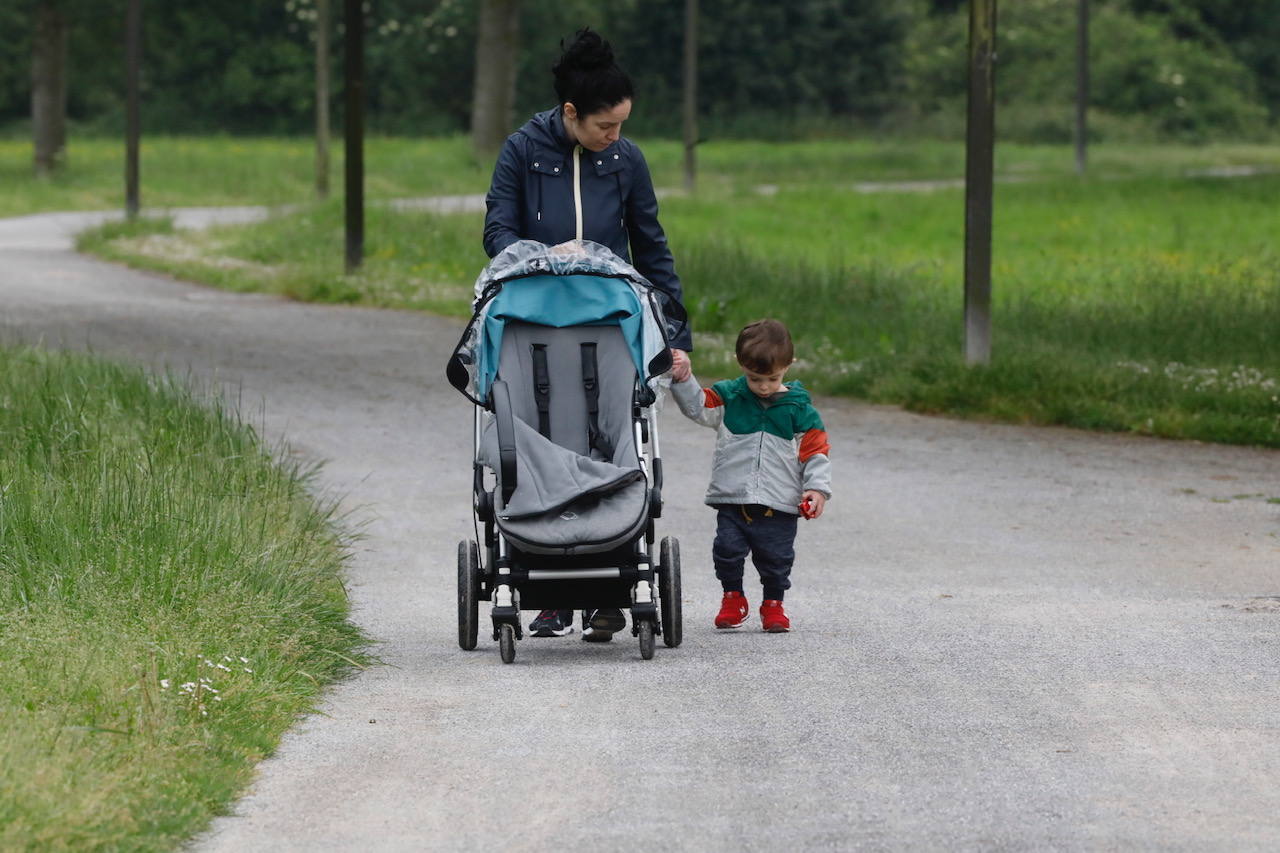 Primeros paseos bajo el orbayu en Gijón de los más pequeños