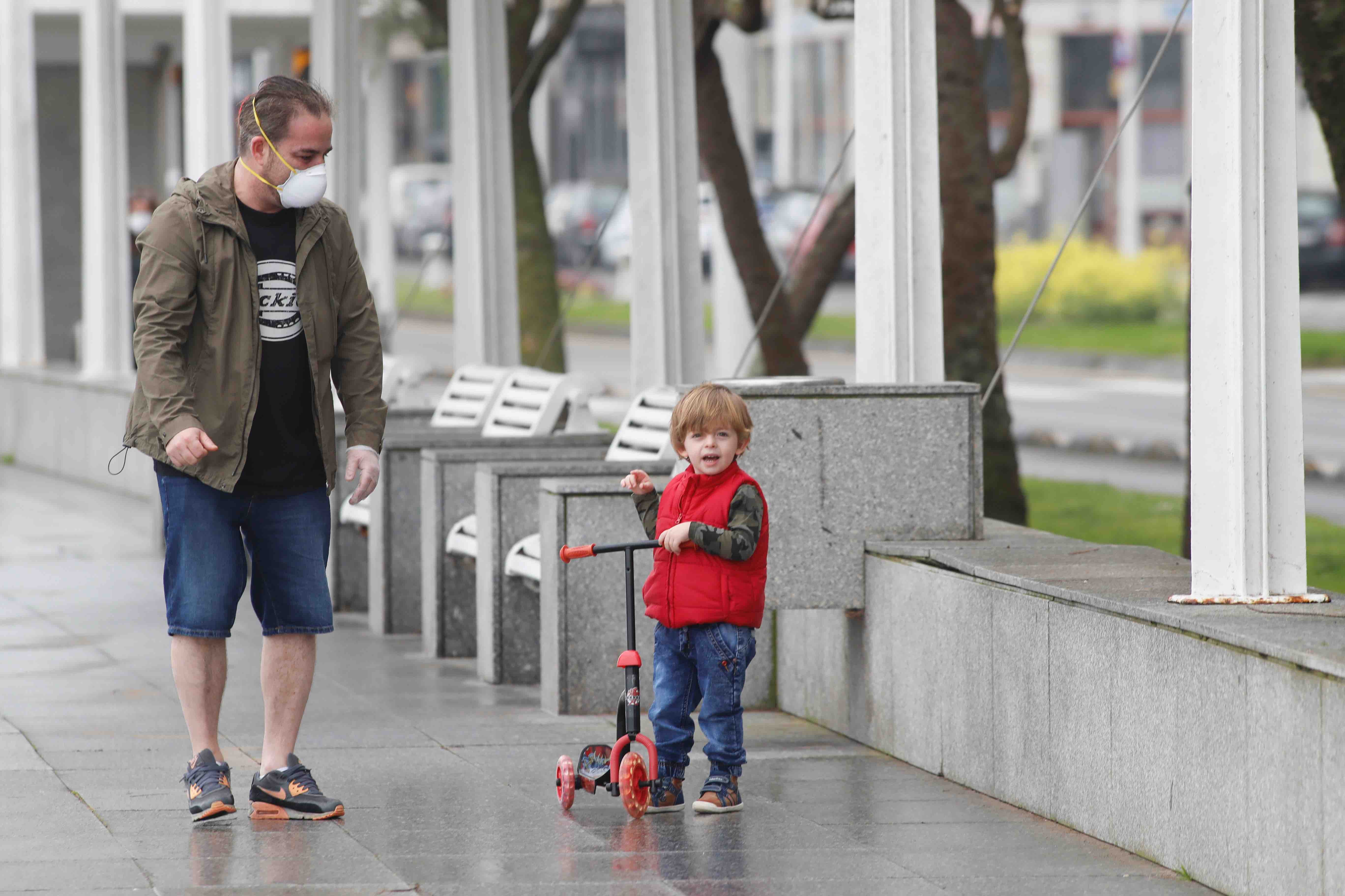 Primeros paseos bajo el orbayu en Gijón de los más pequeños