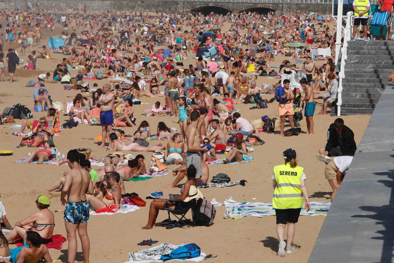 El sol y el calor llevó a la gente a las playas de Gijón. Y lo hizo en masa. Hubo tanta afluencia que incluso tuvo que cerrarse el acceso al principal arenal gijonés, San Lorenzo, para recolocar a las personas. Los acomodadores hoy tuvieron trabajo a destajo para informar a la gente de las condiciones de uso de la playa.