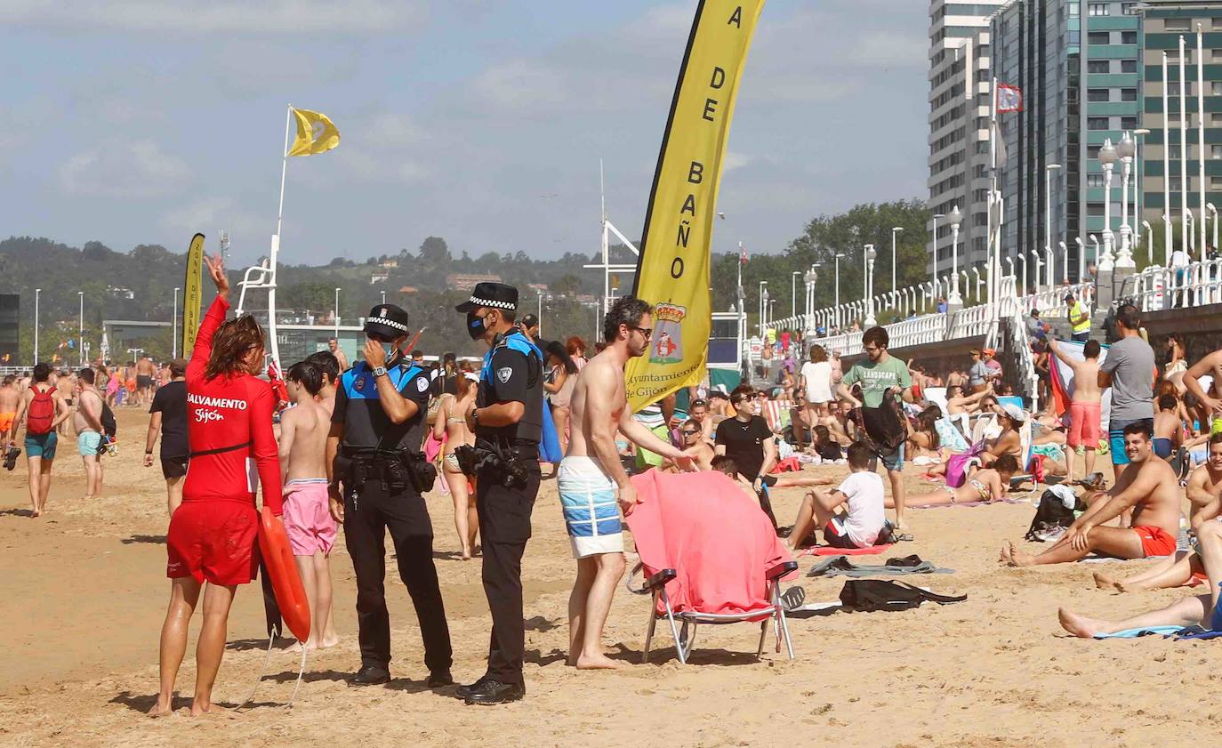 Gijoneses y visitantes han disfrutado del sol y del buen tiempo este martes en las playas. San Lorenzo se ha llenado de bañistas y la Policía Local de Gijón ha intervenido para garantizar el cumplimiento de las medidas de seguridad. 