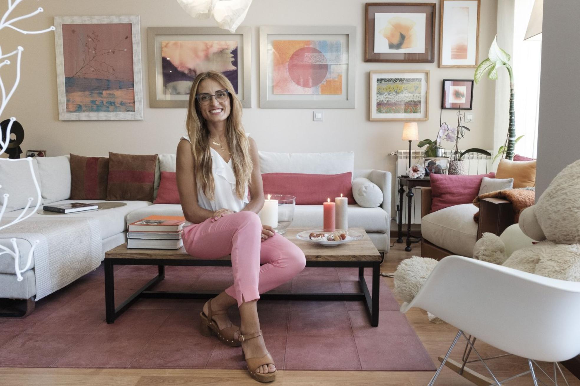 Carmen en el salón de su piso situado en la última planta del edificio, en una urbanización de Nuevo Roces. 