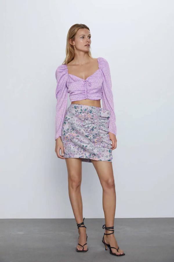 Falda mini de tiro alto, estampado floral y detalle de volante lateral de Zara,7,99 euros.