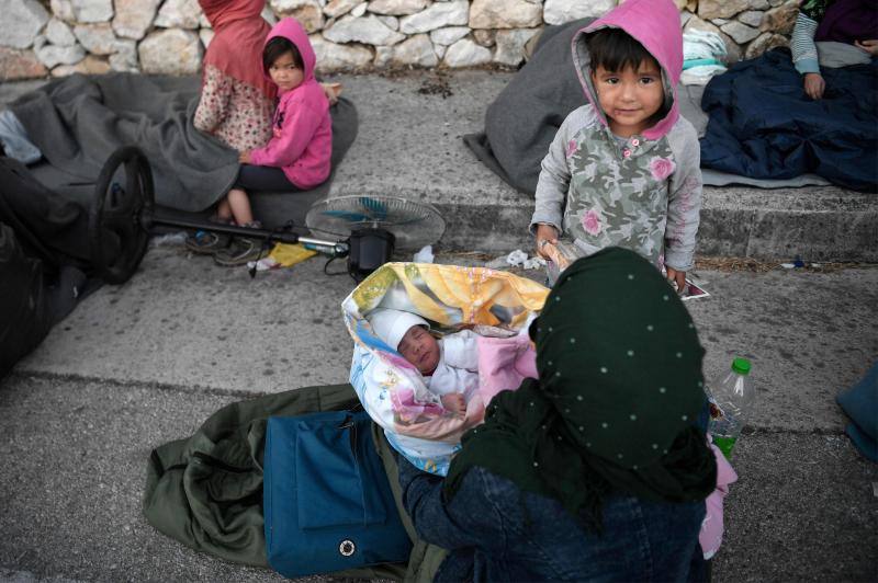 Miles de personas pasan la noche a la intemperie en los alrededores del devastado campo de refugiados de Moria (Lesbos), el más grande de Grecia, a la espera de ser trasladados. Las carreteras que rodean el campo, en el que malvivían 13.000 personas, están repletas de familias que con lo poco que les ha quedado se han instalado en la calzada o en alguna cercana al campo que no ha sido destruida por el incendio del martes por la noche; un incendio que comenzó simultáneamente en varios puntos del campo, poco después de que las autoridades comunicaran a 35 personas que habían dado positivo de covid-19 y que debían ser aisladas. 