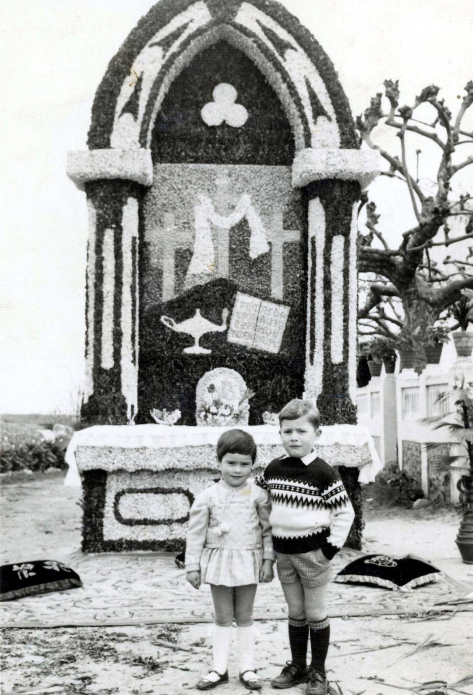 Carmen y Ramón Díaz Alonso, en 1968, ante una glorieta o altar vegetal para las fiestas sacramentales de Naves de Llanes, en la plaza de Santa Ana. 