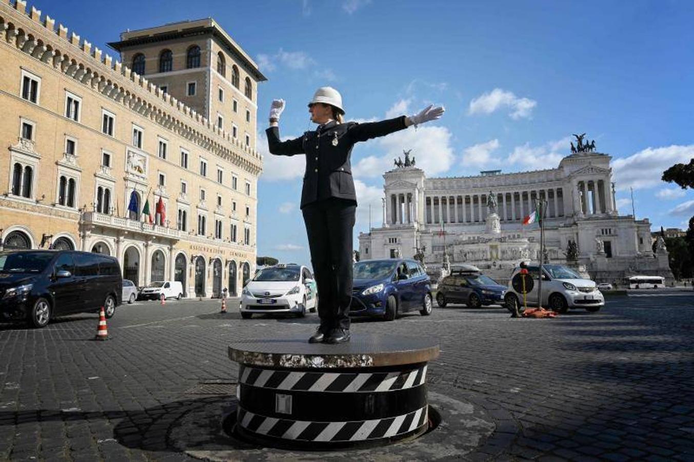 Roma recupera el famoso pedestal de la Piazza Venezia para que un agente de policía regule el caótico tráfico de la zona. La imagen traerá recuerdos a nuestros seguidores más veteranos de los guardias en los cruces de las ciudades asturianas, como el de la imagen en El Náutico