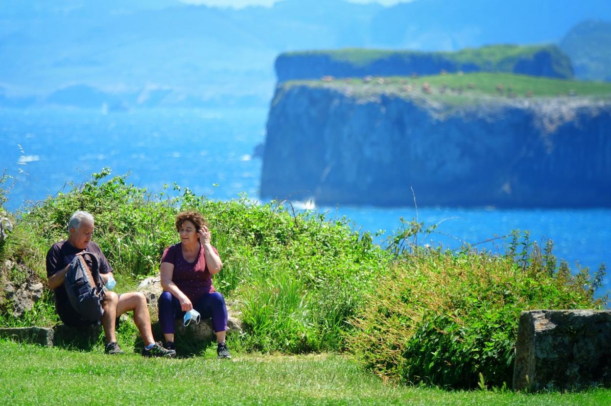 Una pareja disfruta del sol en el llanisco paseo de San Pedro, el pasado sábado. 