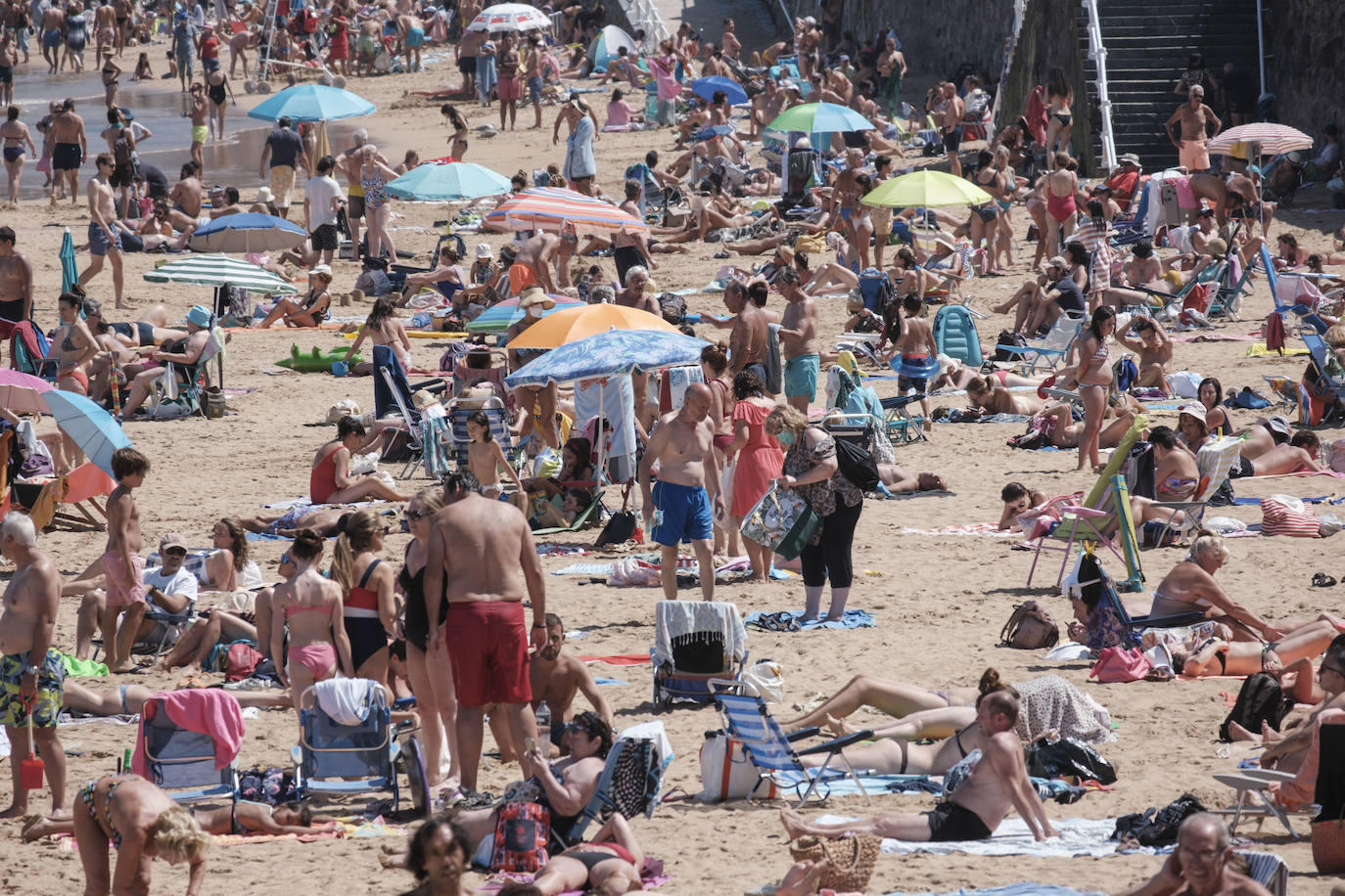 El verano se ha hecho notar este viernes en Asturias. El calor ha empujado a turistas y locales a las playas. De hecho, el arenal de San Lorenzo tuvo que cerrar durante cuatro horas porque se llenó el aforo. 